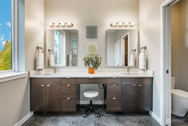 bathroom featuring vanity, toilet, and tile patterned flooring