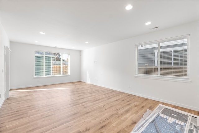 spare room featuring light hardwood / wood-style flooring