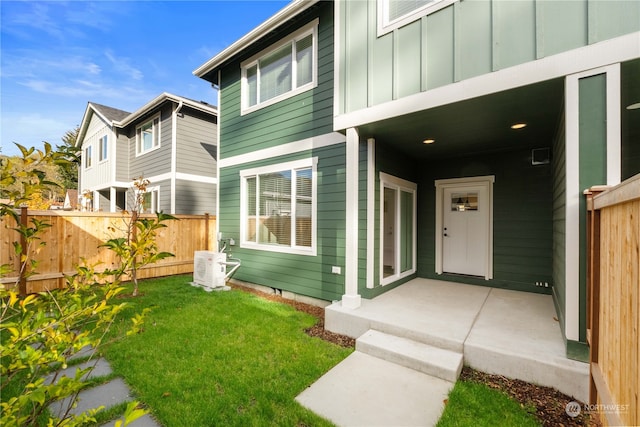 doorway to property with a lawn