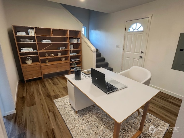 office space with dark hardwood / wood-style floors and electric panel