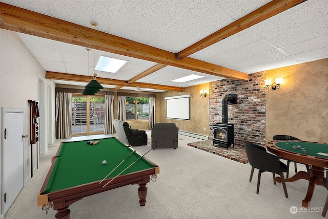 recreation room with pool table, carpet, beamed ceiling, a wood stove, and baseboard heating