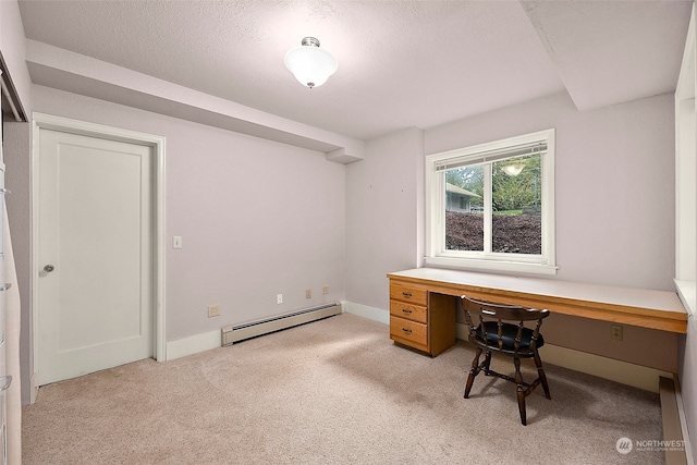 unfurnished office featuring built in desk, light carpet, a textured ceiling, and baseboard heating