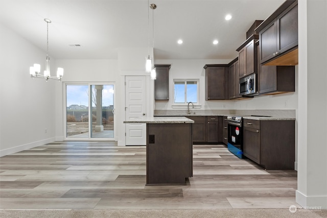 kitchen featuring a center island, light hardwood / wood-style flooring, plenty of natural light, and appliances with stainless steel finishes