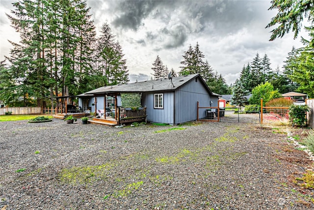 604 Nieland Loop SE, Rainier, WA 98576 - back of house with a wooden deck, fence, and a gate