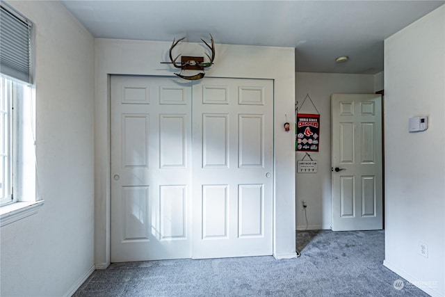 604 Nieland Loop SE, Rainier, WA 98576 - unfurnished bedroom with carpet, a closet, multiple windows, and baseboards