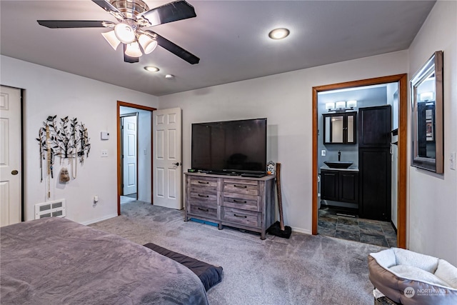 604 Nieland Loop SE, Rainier, WA 98576 - carpeted bedroom featuring baseboards, a sink, connected bathroom, and a ceiling fan
