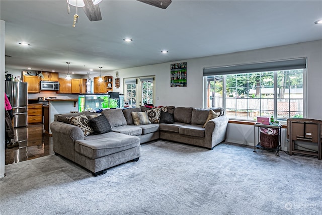 living room featuring carpet flooring and ceiling fan