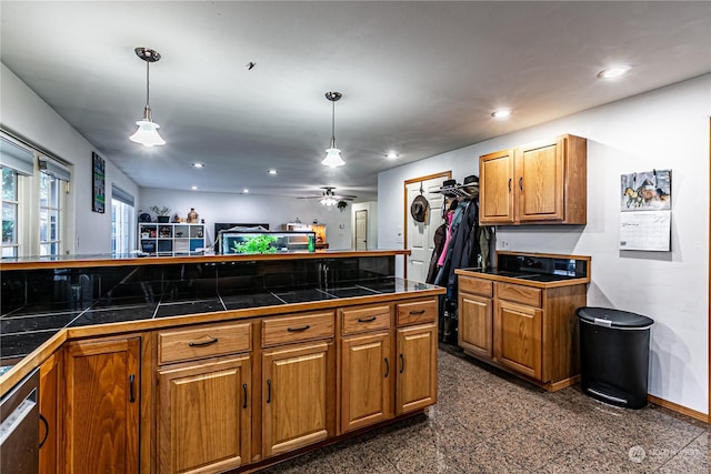 604 Nieland Loop SE, Rainier, WA 98576 - kitchen with brown cabinetry, hanging light fixtures, recessed lighting, stainless steel dishwasher, and granite tiled floors
