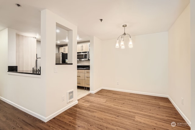 interior space featuring a notable chandelier and wood-type flooring