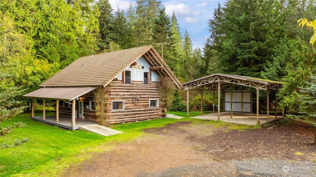 exterior space featuring a storage shed, a lawn, and a carport