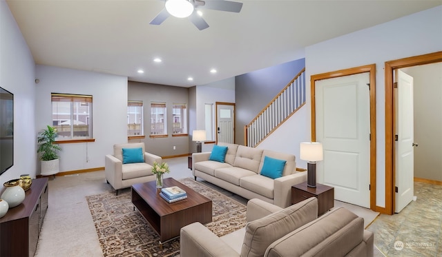 living room with ceiling fan and light colored carpet