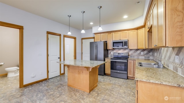 2733 Diamond St Unit D, Milton, WA 98354 - kitchen featuring tasteful backsplash, light stone counters, stainless steel appliances, sink, and a center island