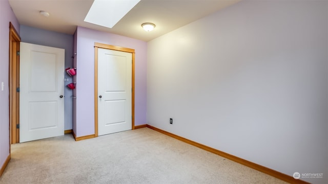 2733 Diamond St Unit D, Milton, WA 98354 - unfurnished bedroom featuring light carpet, a closet, and a skylight
