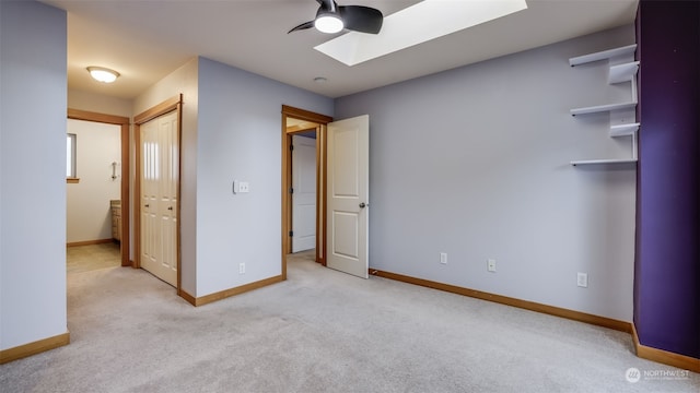 2733 Diamond St Unit D, Milton, WA 98354 - unfurnished bedroom with a skylight, a closet, ceiling fan, connected bathroom, and light colored carpet