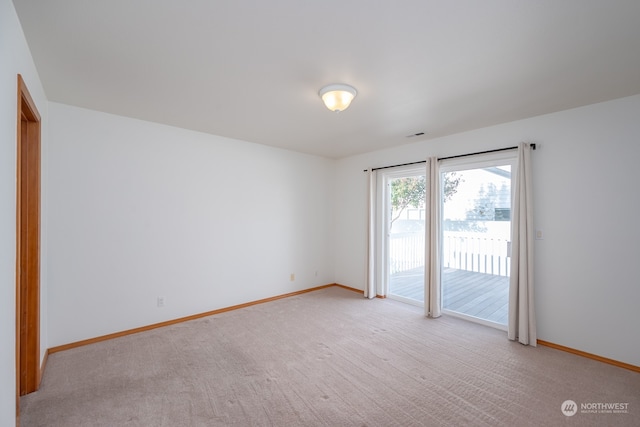 empty room featuring light colored carpet