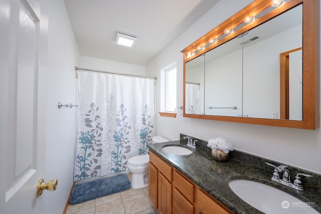 bathroom with toilet, curtained shower, vanity, and tile patterned flooring