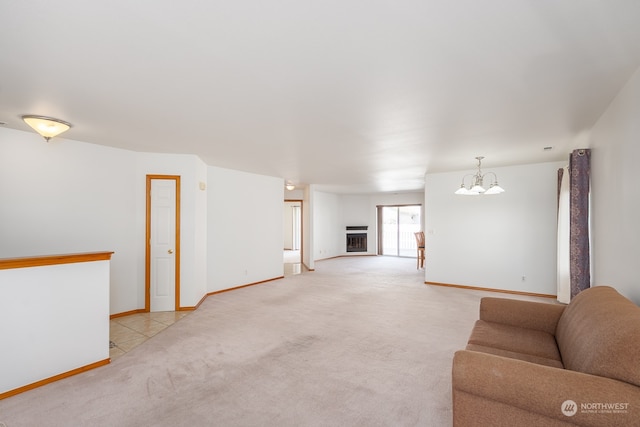 carpeted living room with a chandelier