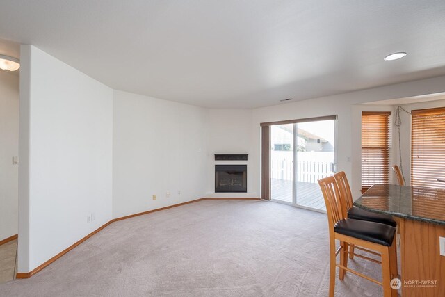 1300 W Marina Dr Unit 34, Moses Lake, WA 98837 - dining room with light carpet, baseboards, and a fireplace