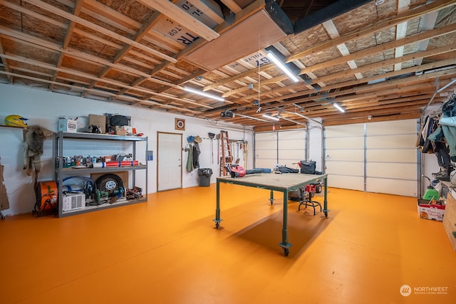 garage featuring a garage door opener and a workshop area