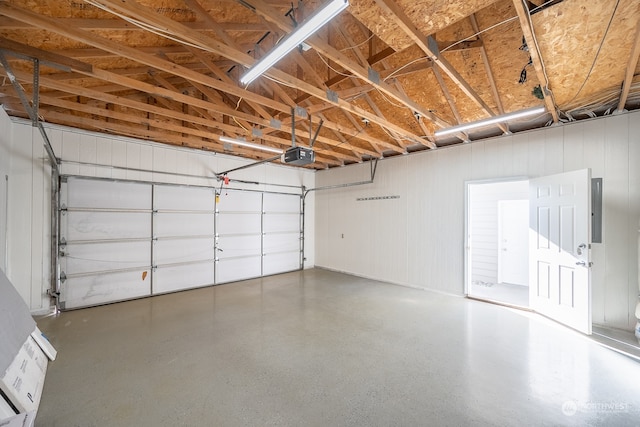 garage featuring a garage door opener and electric panel