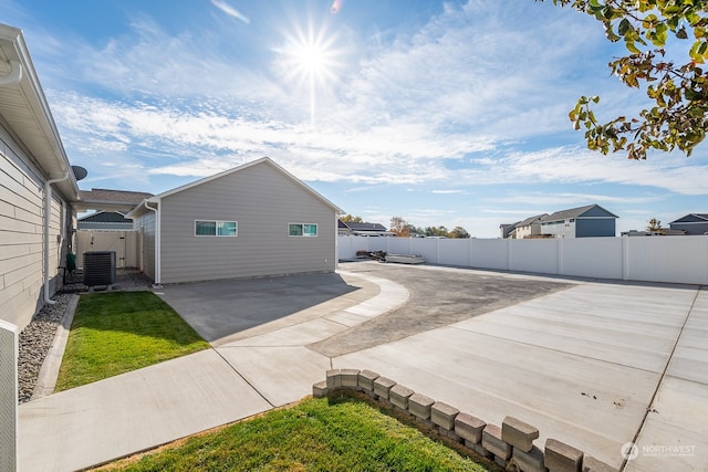 view of property exterior with a patio area and central AC