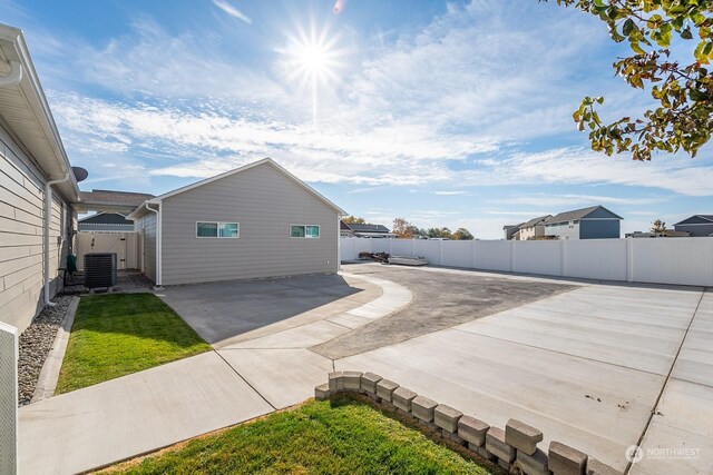 1300 W Marina Dr Unit 34, Moses Lake, WA 98837 - view of home's exterior featuring central AC unit, a patio area, and a fenced backyard