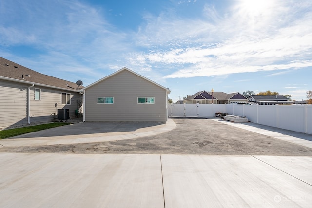 rear view of property featuring a patio and central AC unit