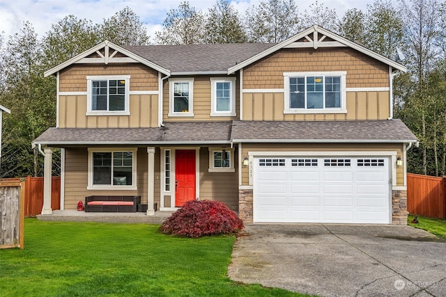 craftsman house with a front yard and a garage