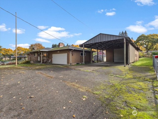 exterior space with a carport and a garage