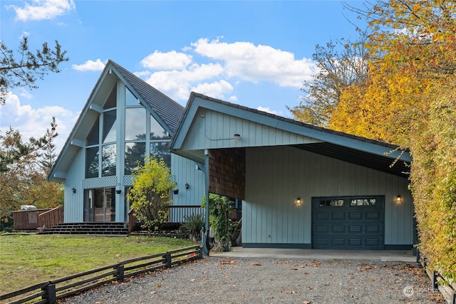 view of front facade with a carport, a front yard, and a garage