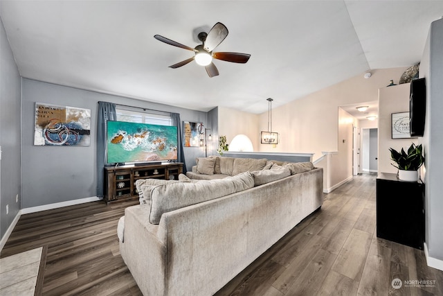 living room featuring vaulted ceiling, dark hardwood / wood-style floors, and ceiling fan with notable chandelier