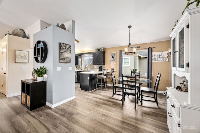 dining space with a notable chandelier and hardwood / wood-style flooring