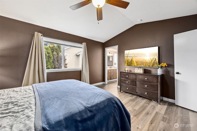 bedroom with light hardwood / wood-style floors, ensuite bathroom, vaulted ceiling, and ceiling fan