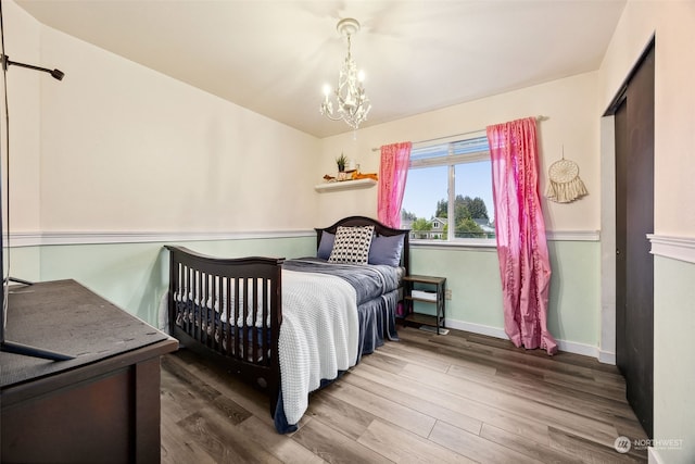 bedroom featuring a chandelier and hardwood / wood-style floors