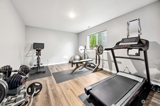 workout area with hardwood / wood-style floors