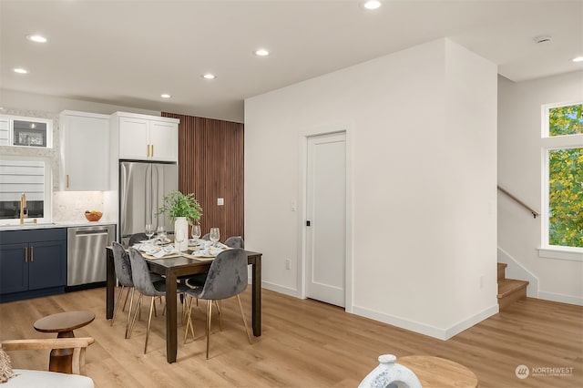 dining room with light hardwood / wood-style flooring and sink