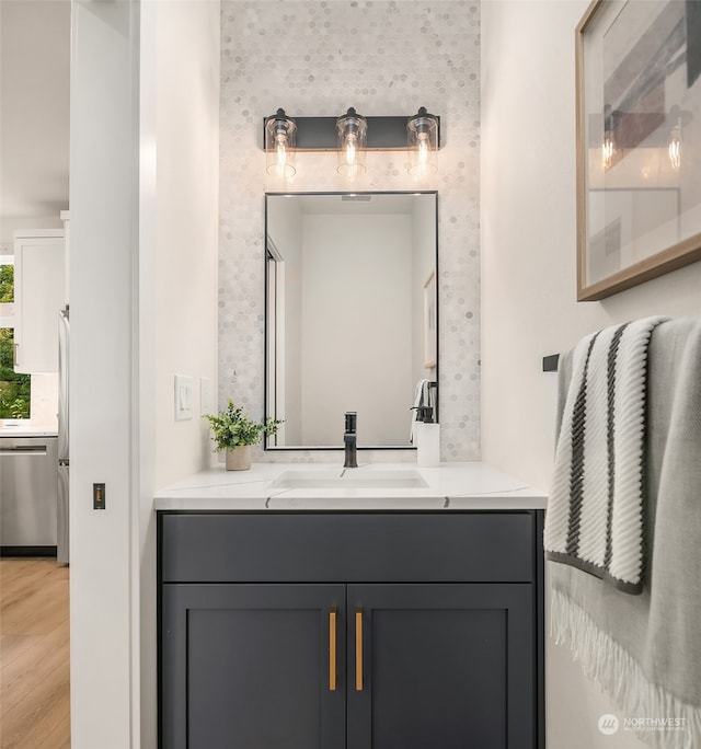 bathroom with hardwood / wood-style floors and vanity