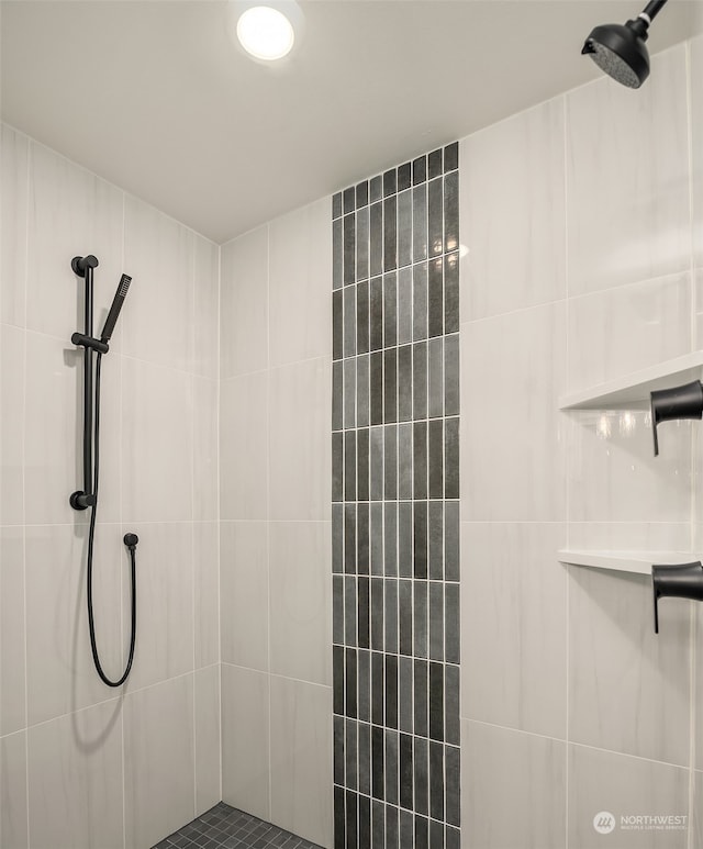 bathroom with a tile shower