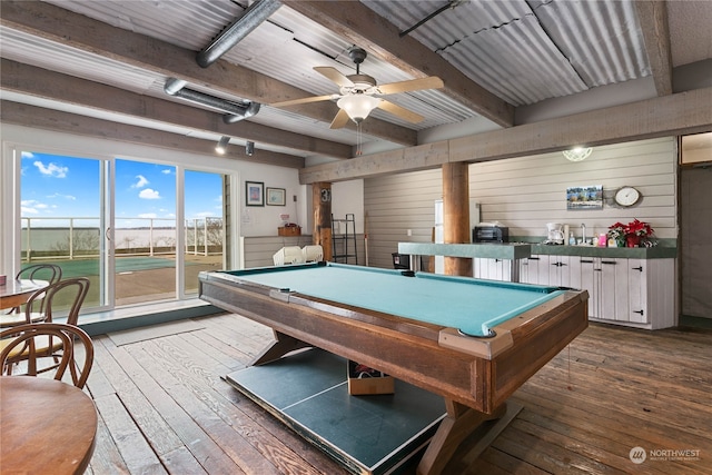 playroom with wood walls, pool table, dark hardwood / wood-style floors, beam ceiling, and ceiling fan