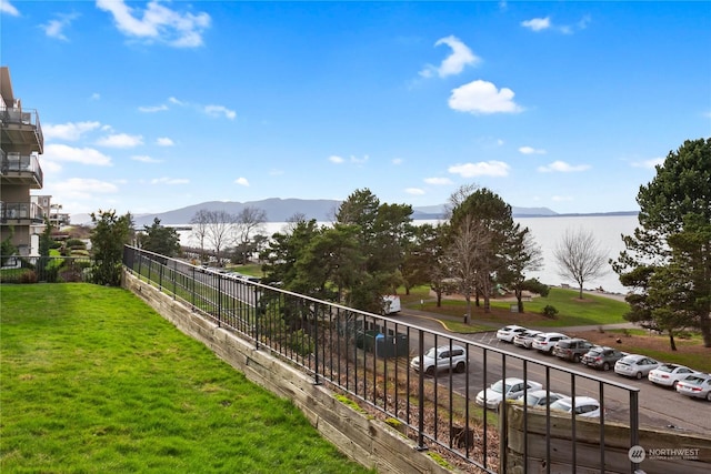 view of yard featuring fence and a mountain view