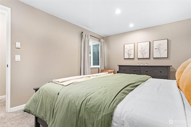 carpeted bedroom featuring baseboards and recessed lighting