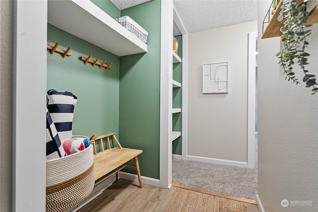 mudroom featuring hardwood / wood-style floors and a textured ceiling