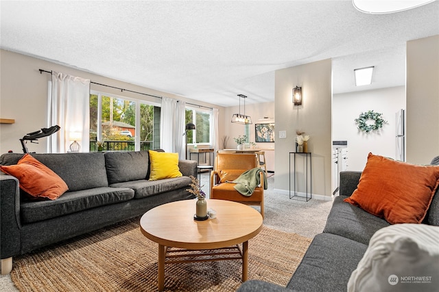 carpeted living room featuring a textured ceiling and an inviting chandelier