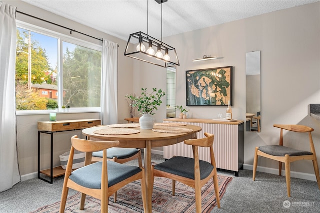 dining space with dark colored carpet, a textured ceiling, and radiator heating unit