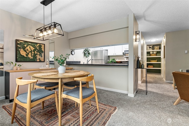 carpeted dining room with a textured ceiling