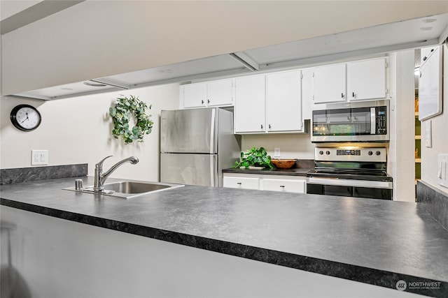 kitchen with stainless steel appliances, sink, and white cabinets