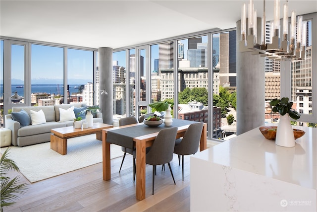 sunroom featuring a notable chandelier and a water view