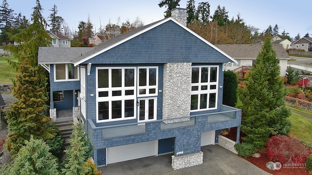 rear view of house featuring a garage