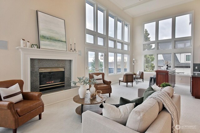 4962 Lilac Dr, Freeland, WA 98249 - carpeted living area featuring ornamental molding, a high end fireplace, a towering ceiling, and baseboards