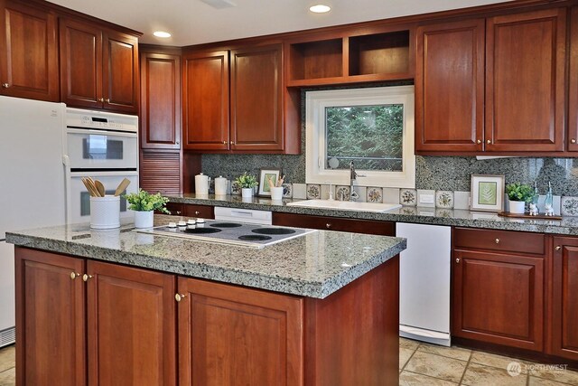 4962 Lilac Dr, Freeland, WA 98249 - kitchen with a sink, white appliances, a center island, tasteful backsplash, and recessed lighting